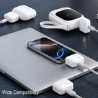 White multi-port USB charging adapter set shown plugged into a silver laptop on a dark wood surface, with a smartphone in the center and additional adapter units around it. The text 'Wide Compatibility' appears in the lower left.